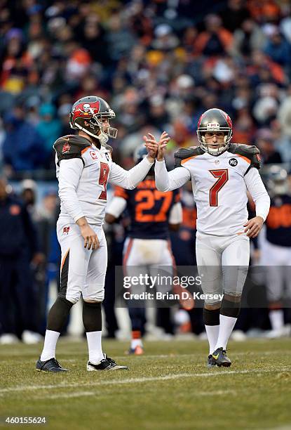 Holder Michael Koenen of the Tampa Bay Buccaneers high-fives kicker Patrick Murray after Murray kicked a field goal during the NFL game against the...