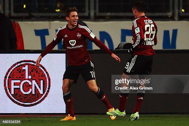 Jakub Sylvestr of Nuernberg celebrates his team's second goal with team mate Alessandro Schoepf during the Second Bundesliga match between 1. FC...