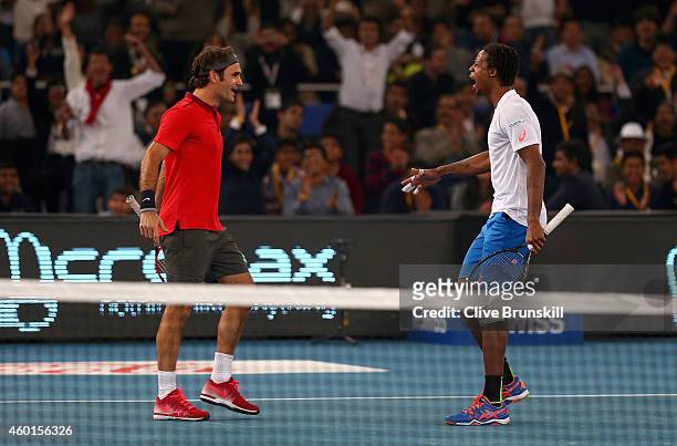 Roger Federer of the Indian Aces celebrates match point with his doubles partner and team mate Gael Monfils after their victory against Novak...