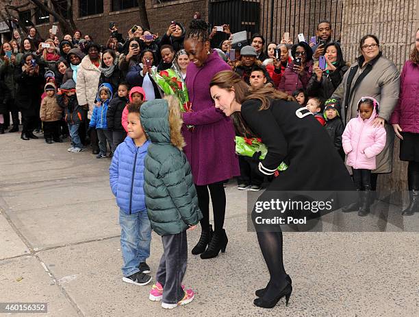 Catherine, Duchess of Cambridge, greets children during a visit with Chirlane McCray, the first lady of New York, to the Northside Center for Child...