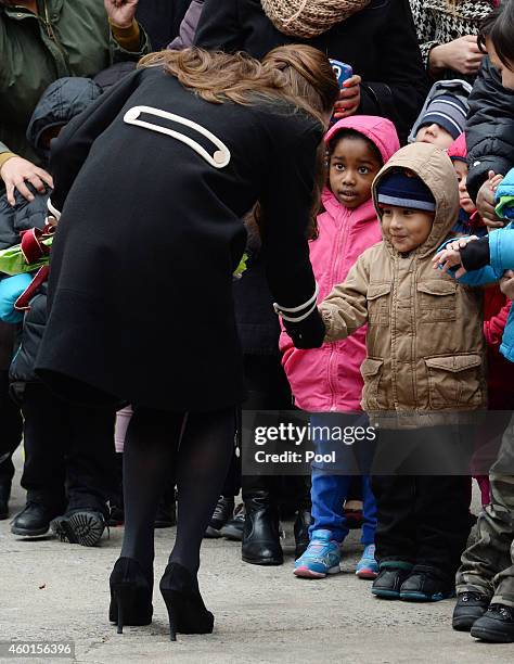 Catherine, Duchess of Cambridge, greets children during a visit with Chirlane McCray, the first lady of New York, to the Northside Center for Child...