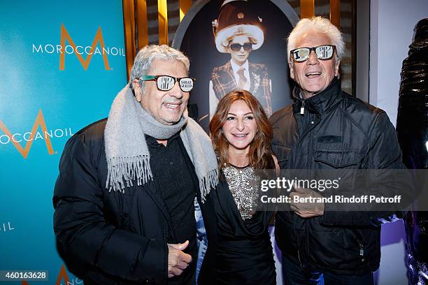 Photo director Gregory Ferrie, Sarah Guetta and singer Gerard Lenorman attends the Sarah Guetta Party in Paris for the first anniversary of the...