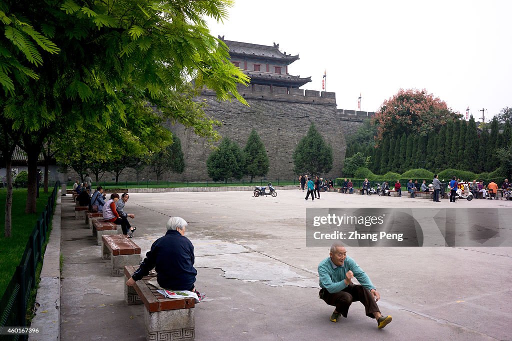 Elderly are doing morning exercises on the square under the...