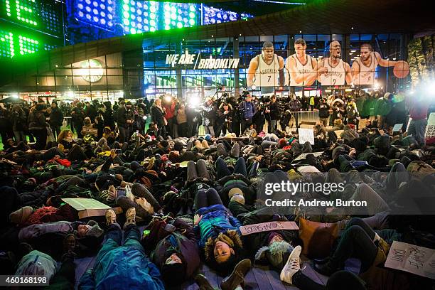 Demonstrators stage a die-in outside the Barclays Center during a Brooklyn Nets game to protest a Staten Island, New York grand jury's decision not...