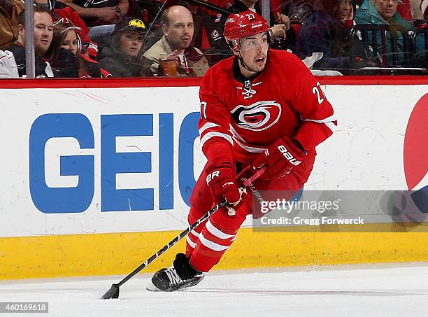 Justin Faulk of the Carolina Hurricanes carries the puck during an NHL game against the New Jersey Devils at PNC Arena on December 8, 2014 in...