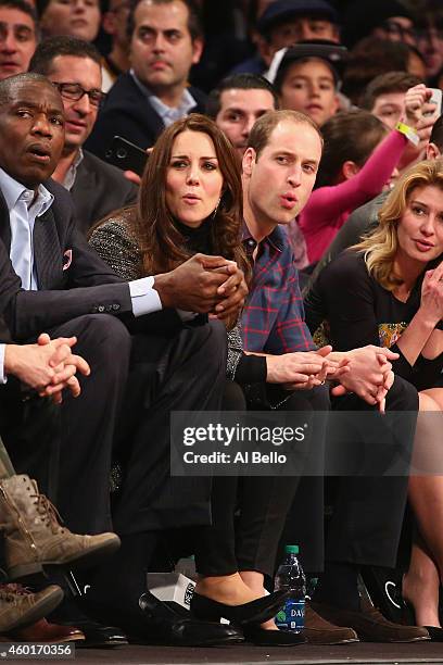 Prince William, Duke of Cambridge and Catherine, Duchess of Cambridge watch the game between the Cleveland Cavaliers and the Brooklyn Nets at...