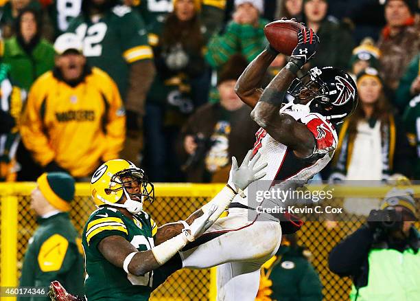 Julio Jones of the Atlanta Falcons completes a touchdown reception against Sam Shields of the Green Bay Packers in the fourth quarter at Lambeau...