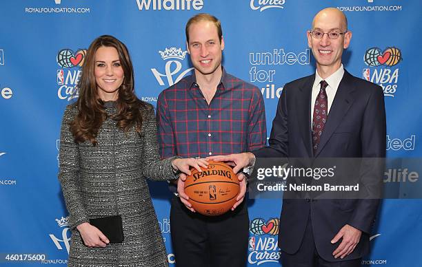 Prince William, Duke of Cambridge and Catherine, Duchess of Cambridge pose with NBA Commissioner Adam Silver as they attend the Cleveland Cavaliers...