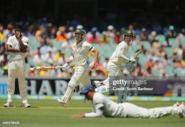 David Warner of Australia hits a boundary as Michael Clarke looks on as they run between the wickets and bowler Mohammed Shami of India looks on...