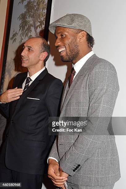 Jean Charles Viti from Shiseido and Didier Drogba attend the 'Prix De La Femme D'Influence 2014' Ceremony at Hotel Du Louvre on December 8, 2014 in...