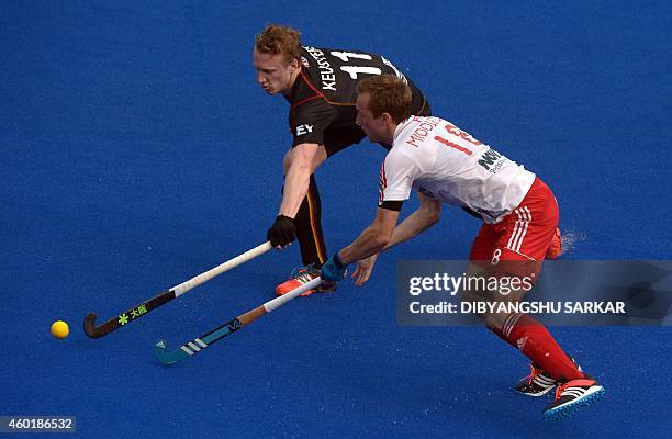 Belgium's hockey player Amaury Keusters and England's Ashley Jackson tussle for the ball during their Hero Hockey Champions Trophy 2014 match at...