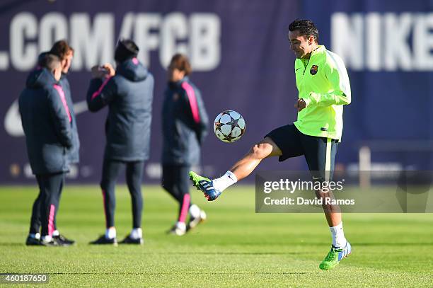 Xavi Hernandez of FC Barcelona juggles the ball during a training session ahead of their UEFA Champions League Group F match against Paris...