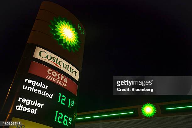 Costcutter and Costa Express coffee logo sit on an illuminated fuel price sign outside a gas station operated by BP Plc in Guildford, U.K., on...