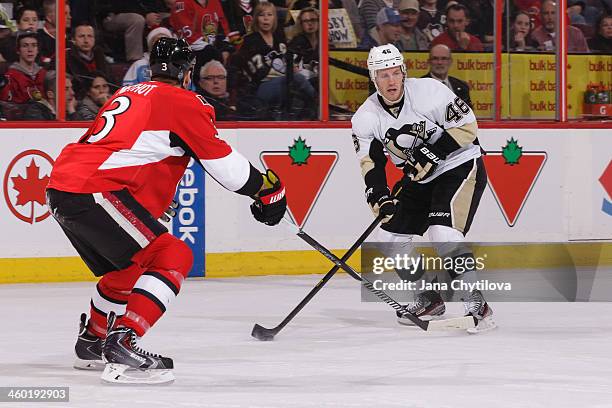 Joe Vitale of the Pittsburgh Penguins skates with the puck against Marc Methot of the Ottawa Senators during an NHL game at Canadian Tire Centre on...