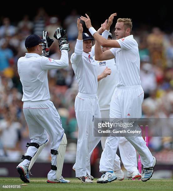 Stuart Broad of England celebrates with teammates after dismissing David Warner of Australia during day one of the Fifth Ashes Test match between...