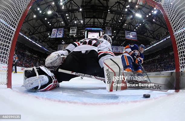 Casey Cizikas of the New York Islanders scores at 15:24 of the first period against Corey Crawford of the Chicago Blackhawks at the Nassau Veterans...