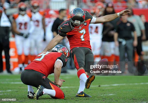 Kicker Patrick Murray of the Tampa Bay Buccaneers kicks a field goal as punter Michael Koenen of the Tampa Bay Buccaneers holds at Raymond James...