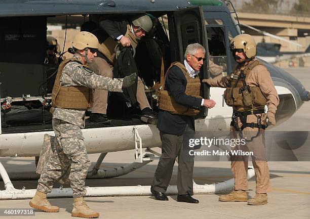 Secretary of Defense Chuck Hagel wears body armor as he steps off a helicopter, December 9, 2014 at Baghdad, Iraq. During his visit Secretary Hagel...