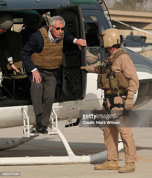 Secretary of Defense Chuck Hagel wears body armor as he steps off a helicopter, December 9, 2014 at Baghdad, Iraq. During his visit Secretary Hagel...