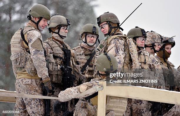 This picture taken on November 21, 2014 shows Latvian troops preparing for live-fire exercises at the Adazi military base outside Riga, Latvia. The...