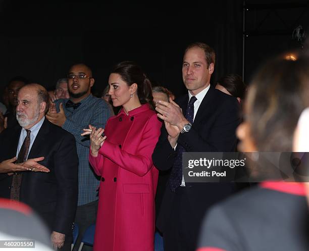 Prince William, Duke of Cambridge and Catherine, Duchess of Cambridge stand to applaud a performance during their visit to The Door on December 9,...