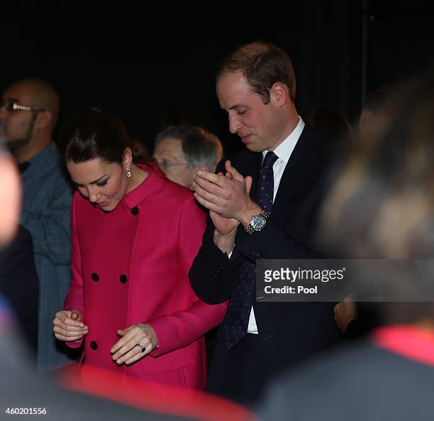Prince William, Duke of Cambridge and Catherine, Duchess of Cambridge stand to applaud a performance during their visit to The Door on December 9,...