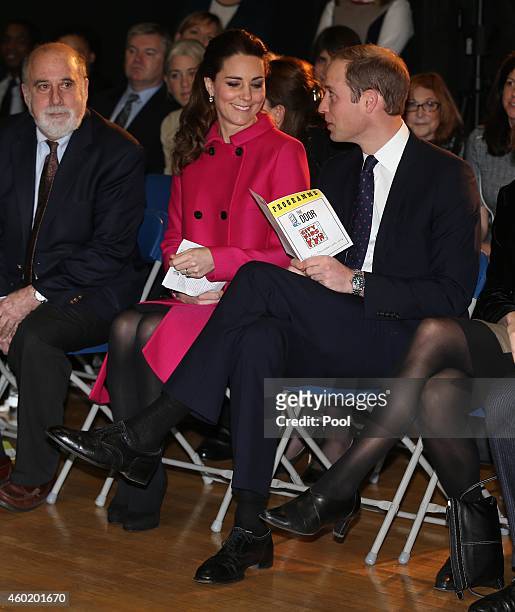 Prince William, Duke of Cambridge and Catherine, Duchess of Cambridge wait for the start of a performance during their visit to The Door on December...