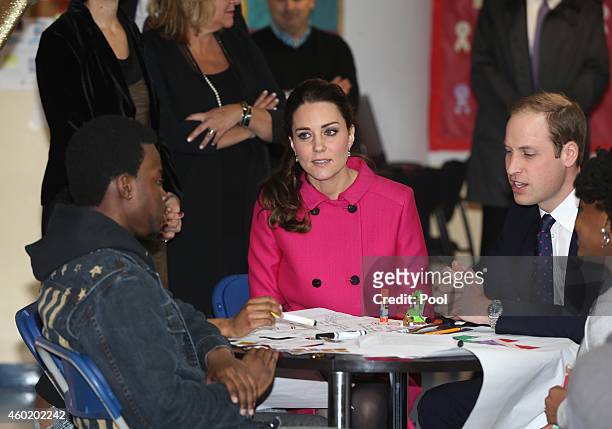Prince William, Duke of Cambridge and Catherine, Duchess of Cambridge speak to people involved with CityKids during their visit to The Door on...