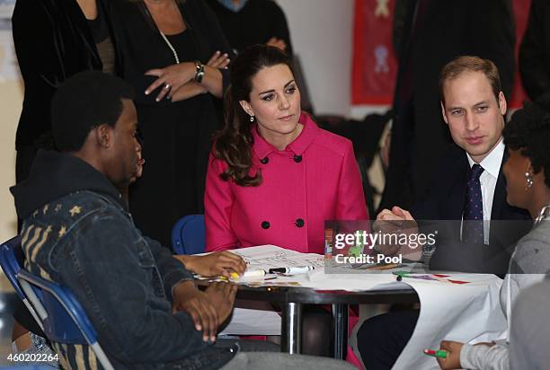 Prince William, Duke of Cambridge and Catherine, Duchess of Cambridge speak to people involved with CityKids during their visit to The Door on...