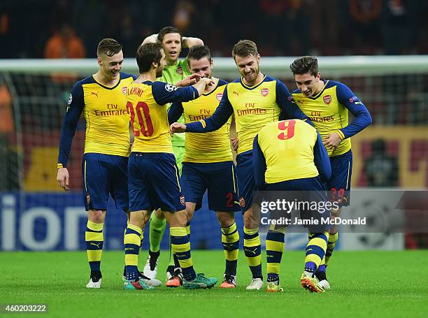 Aaron Ramsey of Arsenal celebrates with team mates as he scores their third goal during the UEFA Champions League Group D match between Galatasaray...