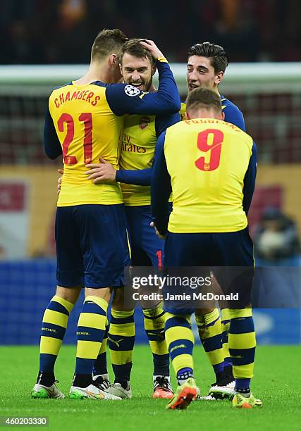 Aaron Ramsey of Arsenal celebrates with team mates as he scores their third goal during the UEFA Champions League Group D match between Galatasaray...