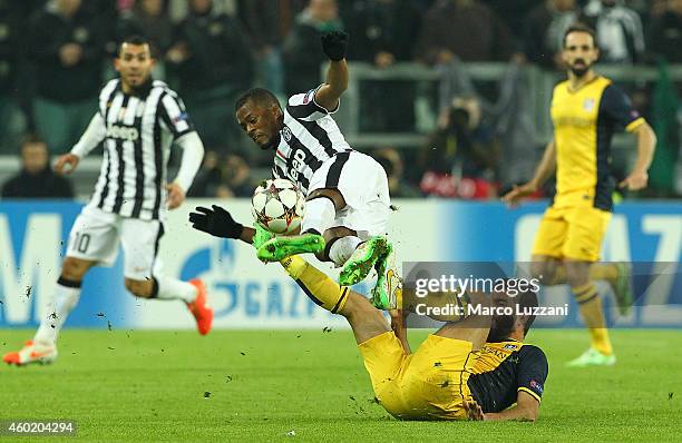 Arda Turan of Club Atletico de Madrid clashes with Patrice Evra of Juventus FC during the UEFA Champions League group A match between Juventus and...