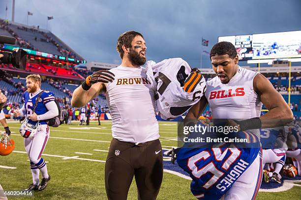 Tank Carder of the Cleveland Browns and Jerry Hughes of the Buffalo Bills exchange pads after the game on November 30, 2014 at Ralph Wilson Stadium...