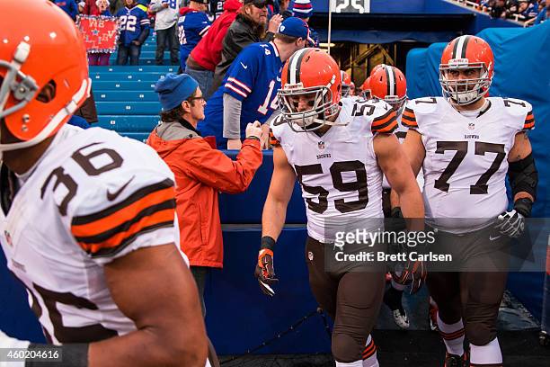 Tank Carder and John Greco of the Cleveland Browns enter the field before the game against the Buffalo Bills on November 30, 2014 at Ralph Wilson...