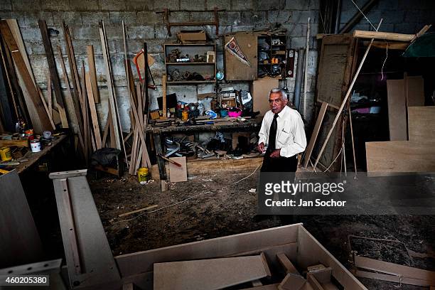 Efraín Cepeda, a table football workshop owner, poses for a picture in his workshop on March 03, 2012 in Quito, Ecuador. Table football, also known...