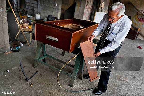 Efraín Cepeda, a table football workshop owner, shows an unfinished table in his workshop on March 03, 2012 in Quito, Ecuador. Table football, also...