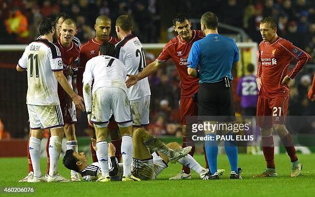 Liverpool players remonstrate with Dutch referee Bjorn Kuipers after Liverpool's Serbian midfielder Lazar Markovic was sent off after apparently...