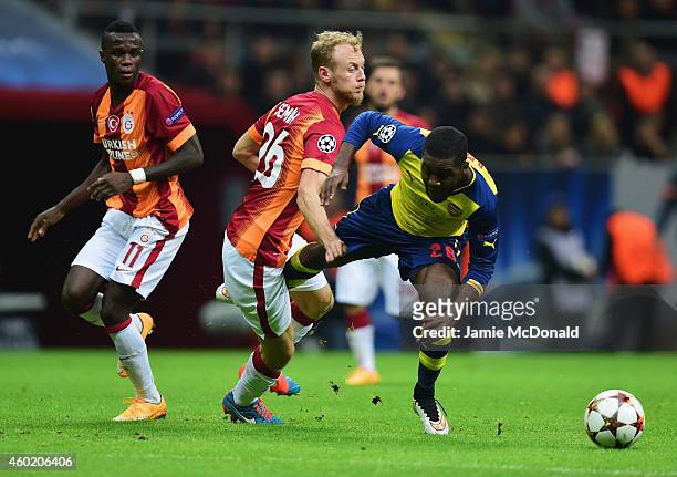 Joel Campbell of Arsenal takes on Bruma and Semih Kaya of Galatasaray during the UEFA Champions League Group D match between Galatasaray AS and...