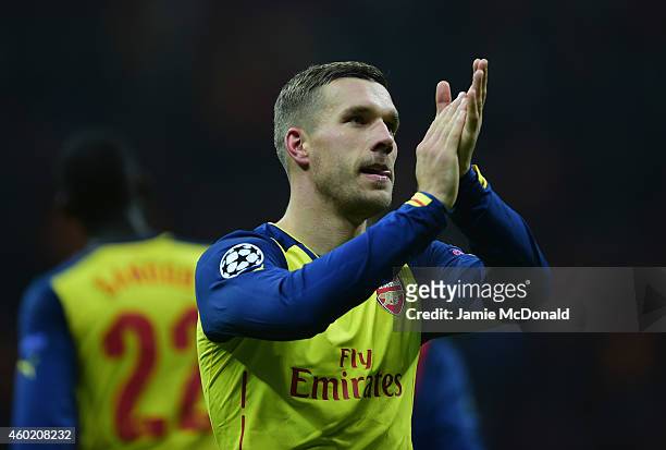 Lukas Podolski of Arsenal applauds the crowd after victory in the UEFA Champions League Group D match between Galatasaray AS and Arsenal FC at Ali...