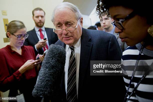 Senator Carl Levin, a Democrat from Michigan, speaks to a reporter in the U.S. Capitol Building basement before voting in Washington, D.C., U.S., on...