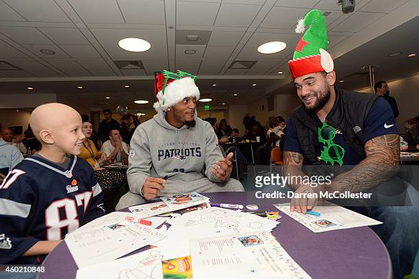 New England Patriots Patrick Chung and Mike Hoomanawanui visit with Camryn at Boston Children's Hospital December 9, 2014 in Boston, Massachusetts.