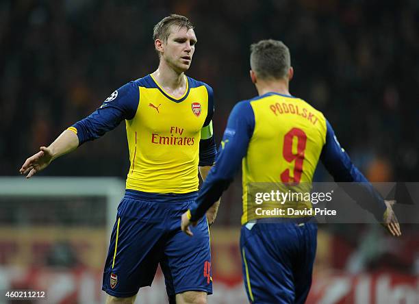 Per Mertesacker and Lukas Podolski of Arsenal during the match between Galatasaray and Arsenal in the UEFA Champions League on December 9, 2014 in...