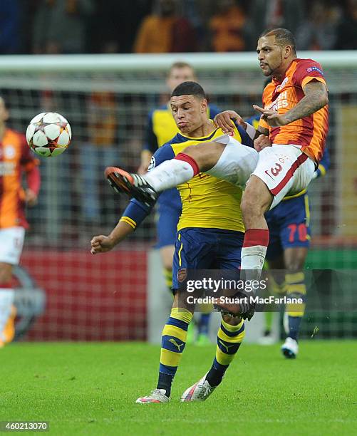 Alex Oxlade-Chamberlain of Arsenal challenged by Felipe Melo during the UEFA Champions League match between Galatasaray and Arsenal at the Turk...