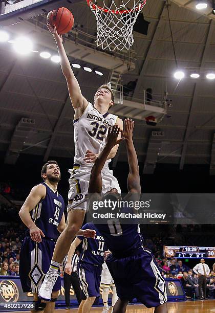 Steve Vasturia of the Notre Dame Fighting Irish shoots the ball over Chris Martin of the Mount St. Mary's Mountaineers at Purcell Pavilion on...
