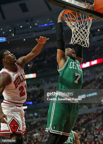 Jared Sullinger of the Boston Celtics dunks past Jimmy Butler of the Chicago Bulls at the United Center on January 2, 2014 in Chicago, Illinois. NOTE...