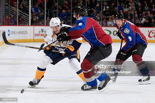 Craig Smith of the Nashville Predators controls the puck against Jan Hejda of the Colorado Avalanche at Pepsi Center on December 9, 2014 in Denver,...