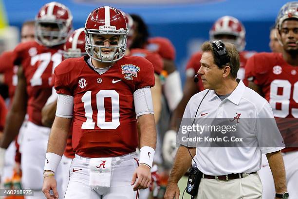 McCarron of the Alabama Crimson Tide talks with head coach Nick Saban during a time out against the Oklahoma Sooners during the Allstate Sugar Bowl...