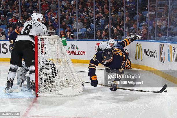 Marcus Foligno of the Buffalo Sabres controls the puck while airborne as Drew Doughty of the Los Angeles Kings defends on December 9, 2014 at the...