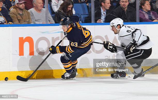 Tyler Ennis of the Buffalo Sabres skates with the puck against Drew Doughty of the Los Angeles Kings on December 9, 2014 at the First Niagara Center...