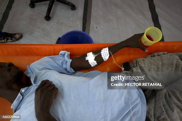 Cholera patient is treated at the MSF ?Center for Emergency Care in the Martissan area of Port-au-Prince on December 9, 2014. MSF currently has four...